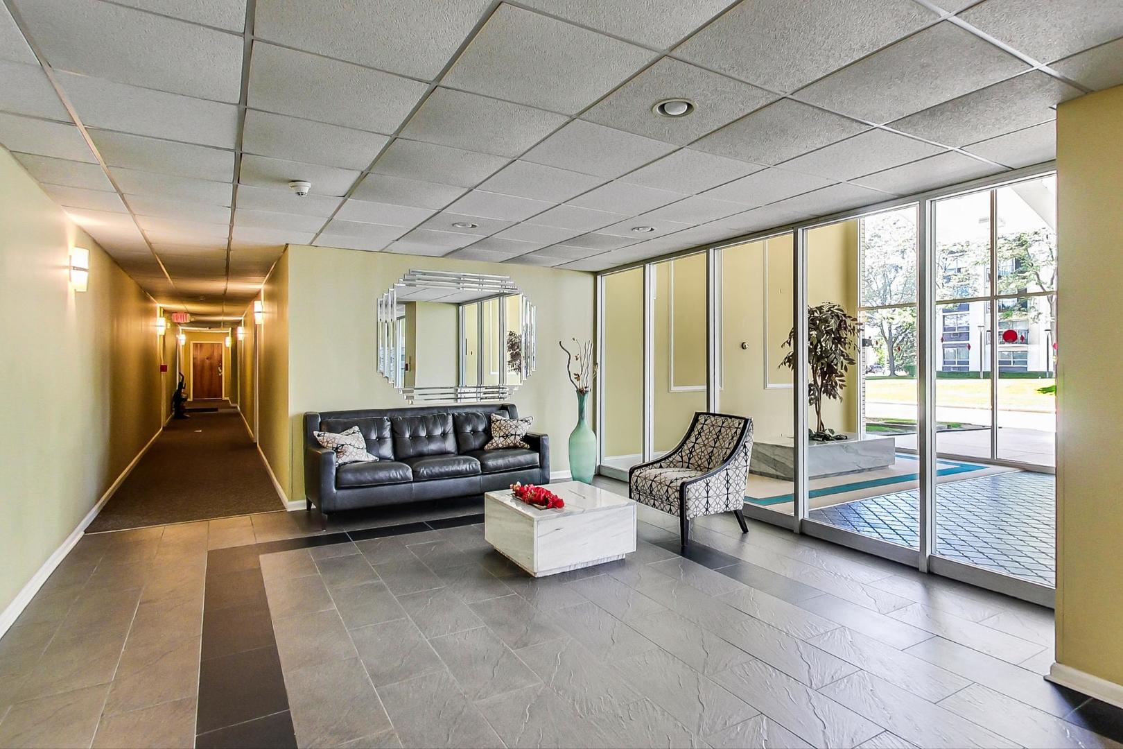 9009 Golf Road, Unit 8B Des Plaines, IL 60016 - Photo 10 of 42 a living room with furniture and a floor to ceiling window