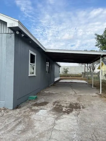 a backyard of a house with table and chairs