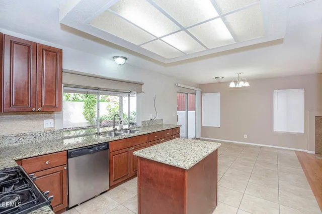a kitchen with a sink a counter top space and cabinets