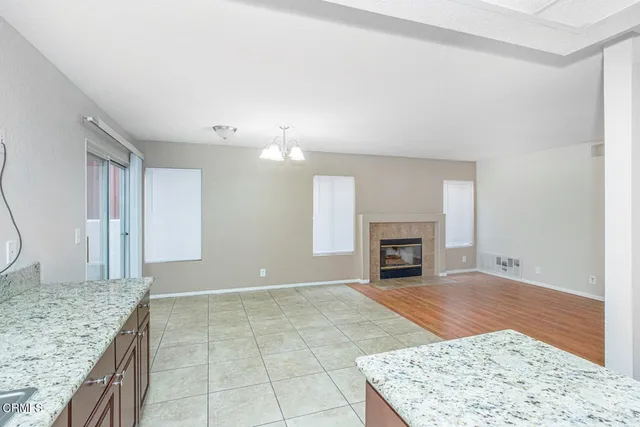 a view of an empty room and fire place