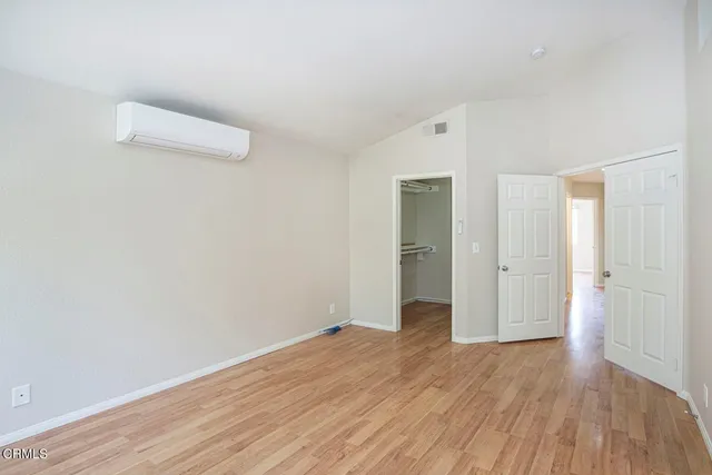 a view of a room with wooden floor and white doors