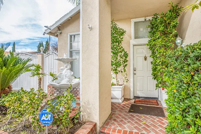 a front view of a house with a yard and flowers