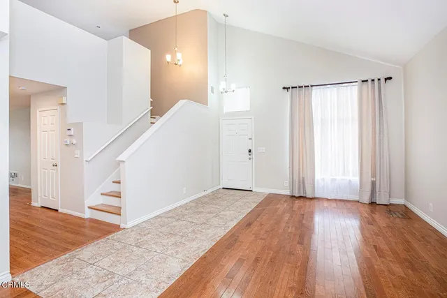 a view of a hallway view with wooden floor and staircase