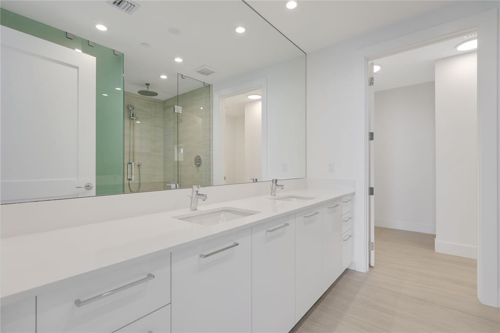 151 North Seabreeze Boulevard, Unit 903E Fort Lauderdale, FL 33304 - Photo 18 of 49 a bathroom with a double vanity sink mirror and double