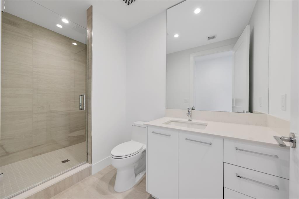 151 North Seabreeze Boulevard, Unit 903E Fort Lauderdale, FL 33304 - Photo 26 of 49 a bathroom with a sink a toilet and shower