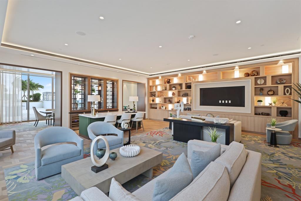 151 North Seabreeze Boulevard, Unit 903E Fort Lauderdale, FL 33304 - Photo 35 of 49 a living room with furniture and a flat screen tv