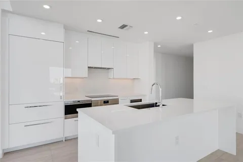 a kitchen with a sink a stove and cabinets