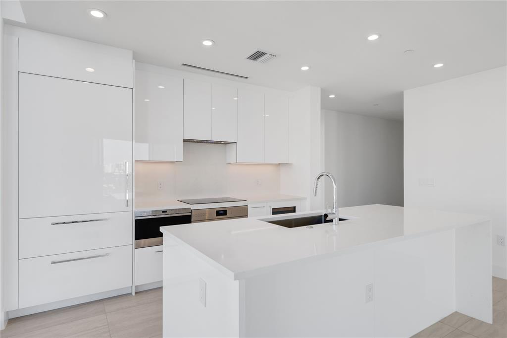 151 North Seabreeze Boulevard, Unit 903E Fort Lauderdale, FL 33304 - Photo 4 of 49 a kitchen with a sink a stove and cabinets