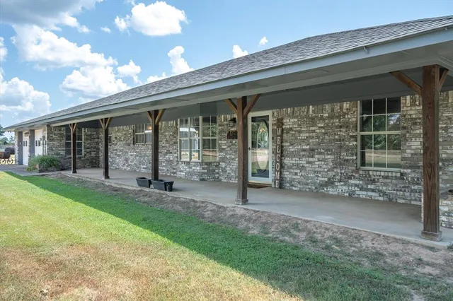 a view of a house with backyard porch and garden