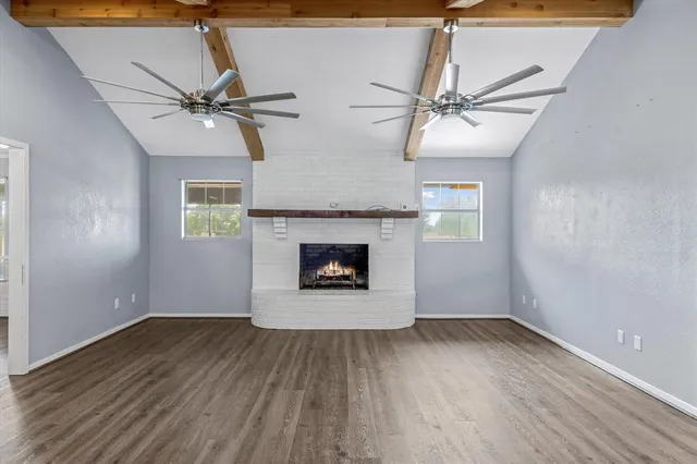 wooden floor in an empty room with a fireplace