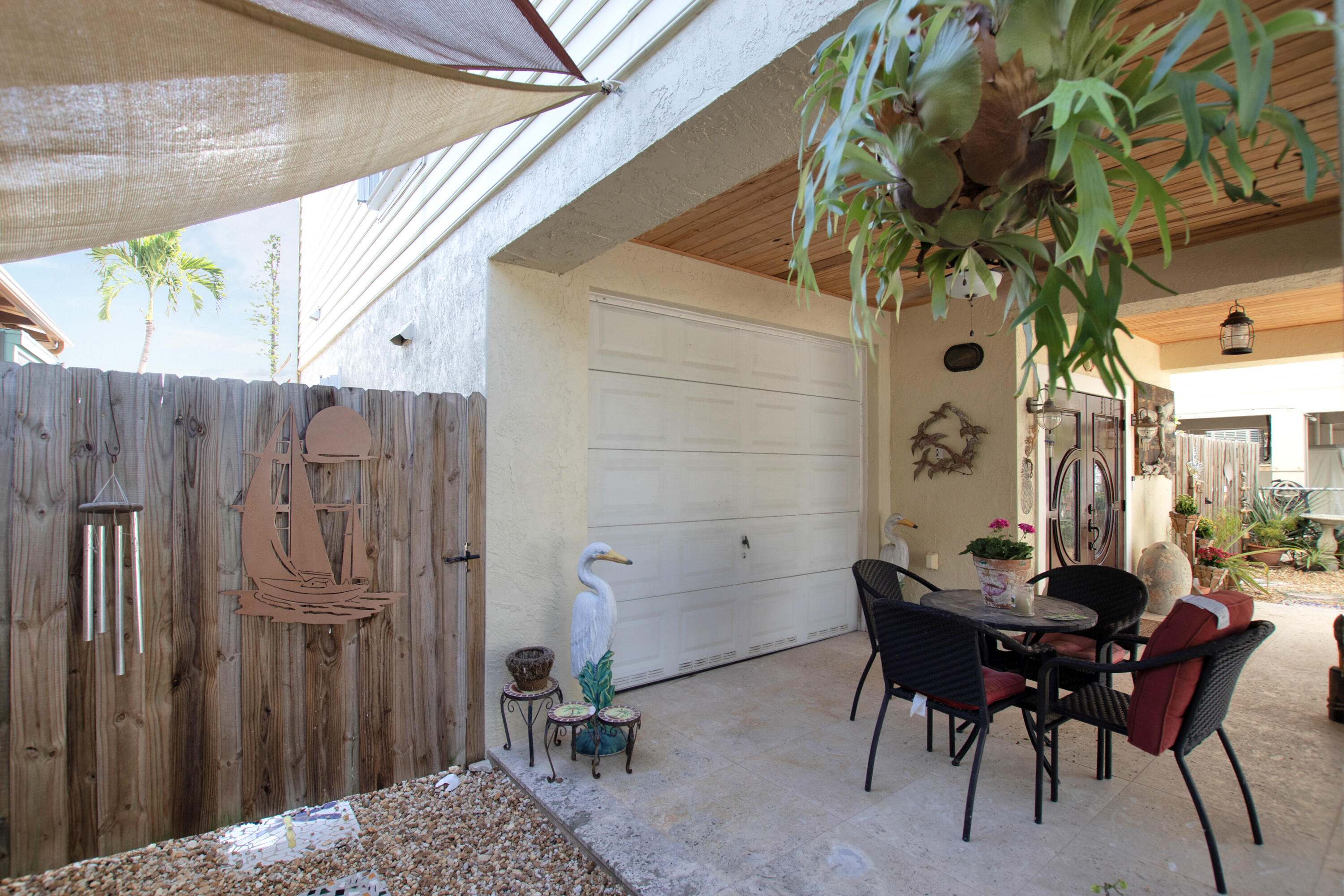 13 Flamingo Road Key Largo, FL 33037 - Photo 11 of 63 a backyard of a house with table and chairs