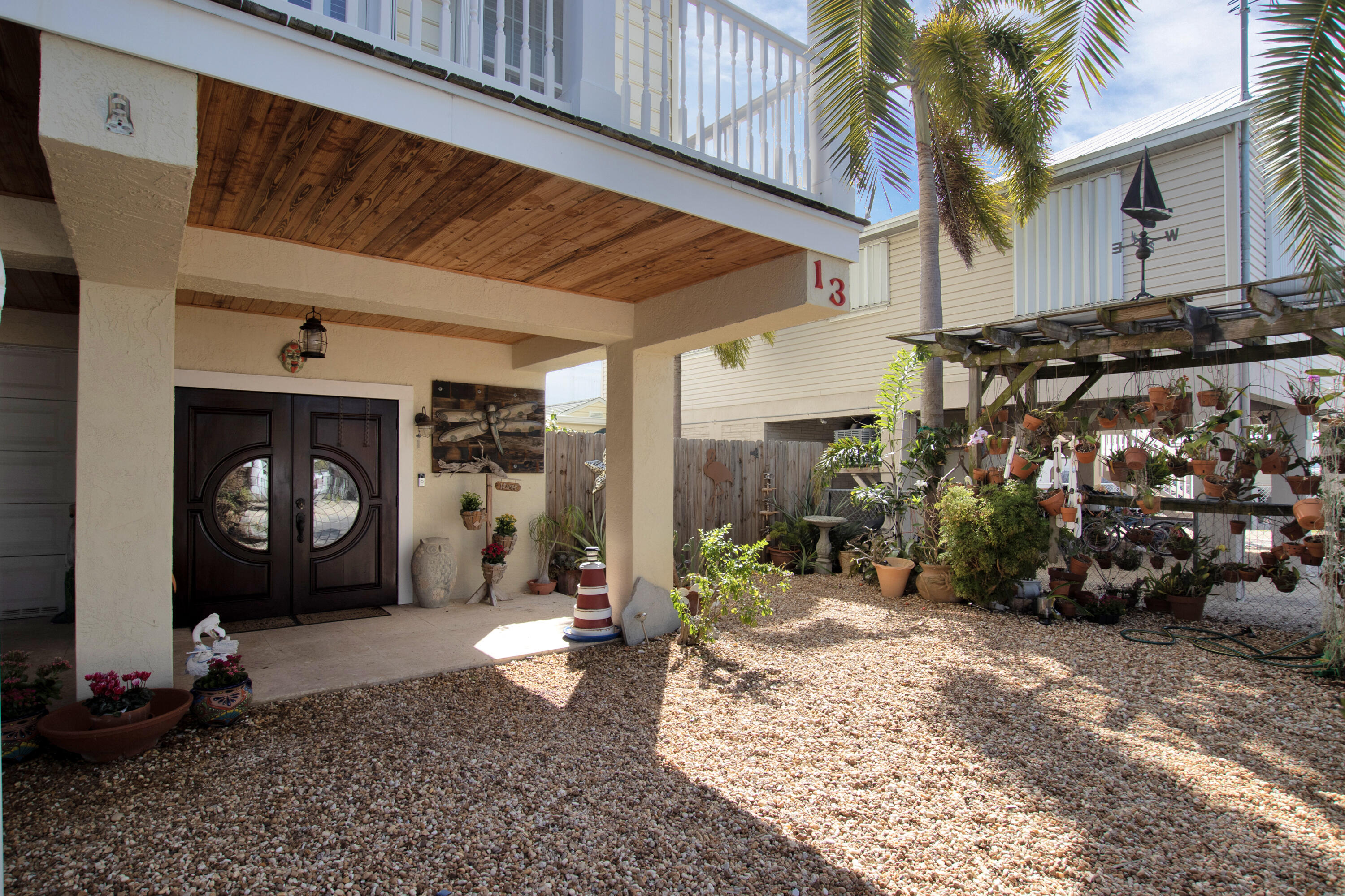 13 Flamingo Road Key Largo, FL 33037 - Photo 12 of 63 a front view of a house with a yard