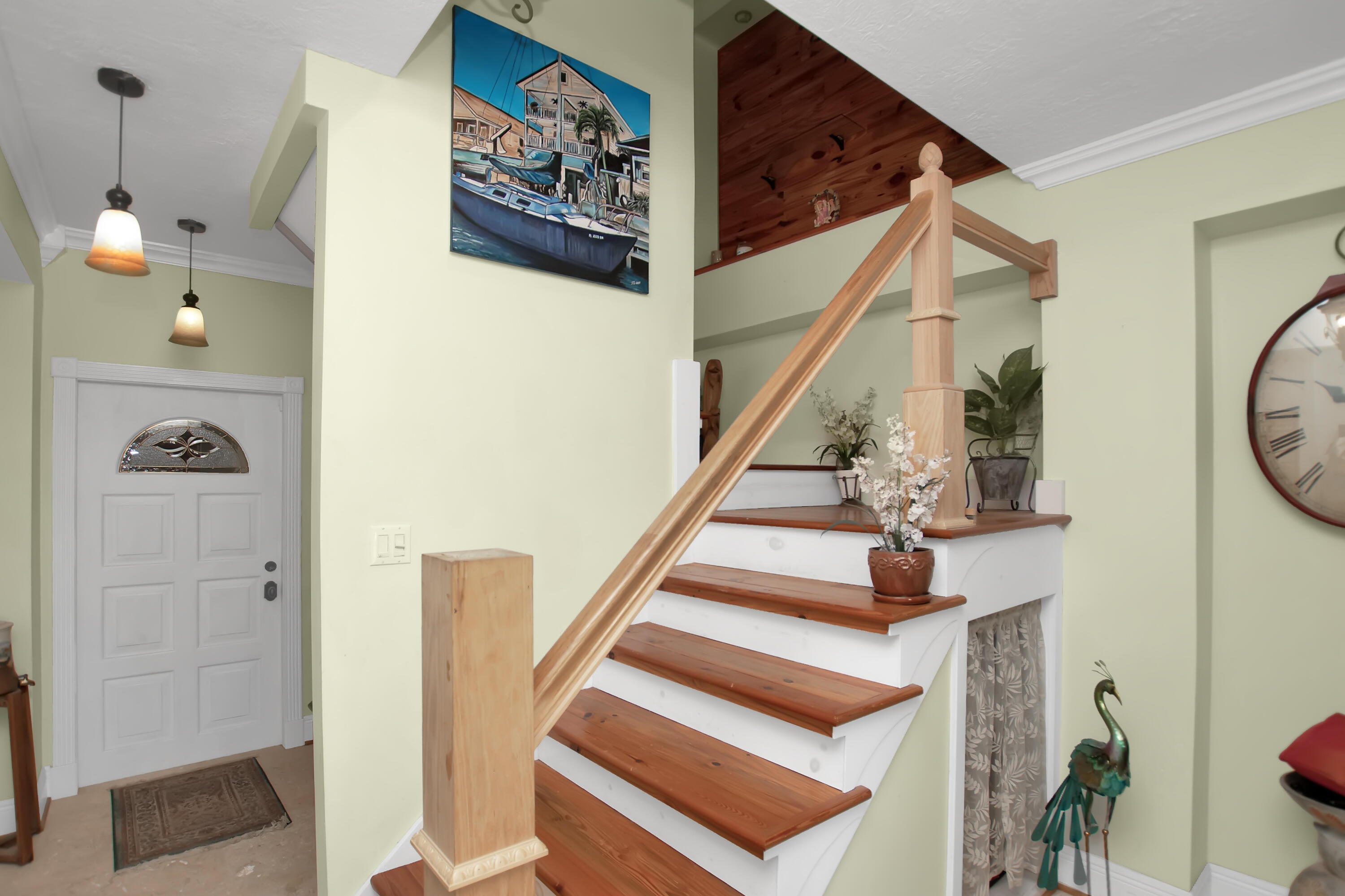 13 Flamingo Road Key Largo, FL 33037 - Photo 13 of 63 a view of staircase with lots of frames on wall and a dining table