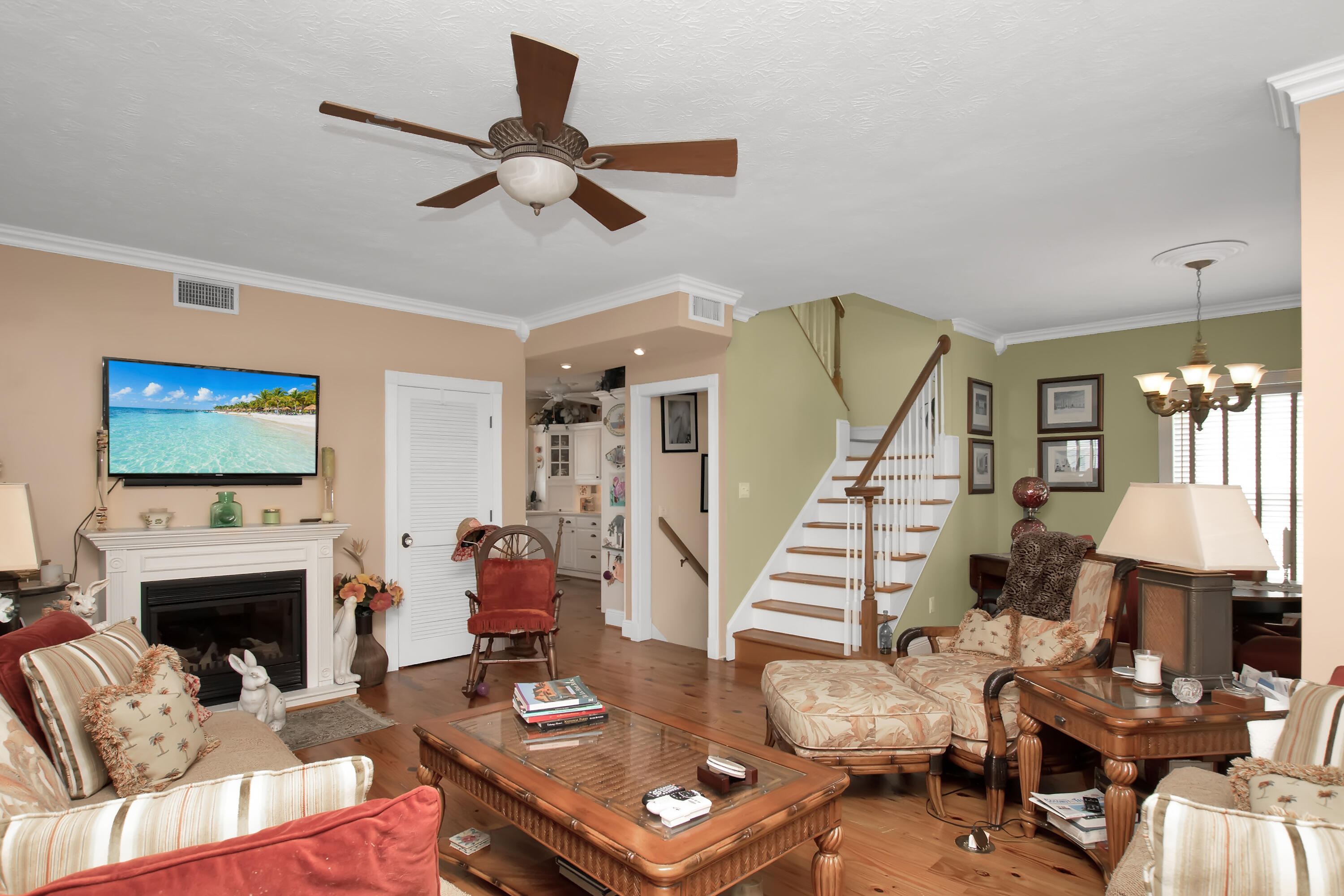 13 Flamingo Road Key Largo, FL 33037 - Photo 63 of 63 a living room with furniture a fireplace and a flat screen tv