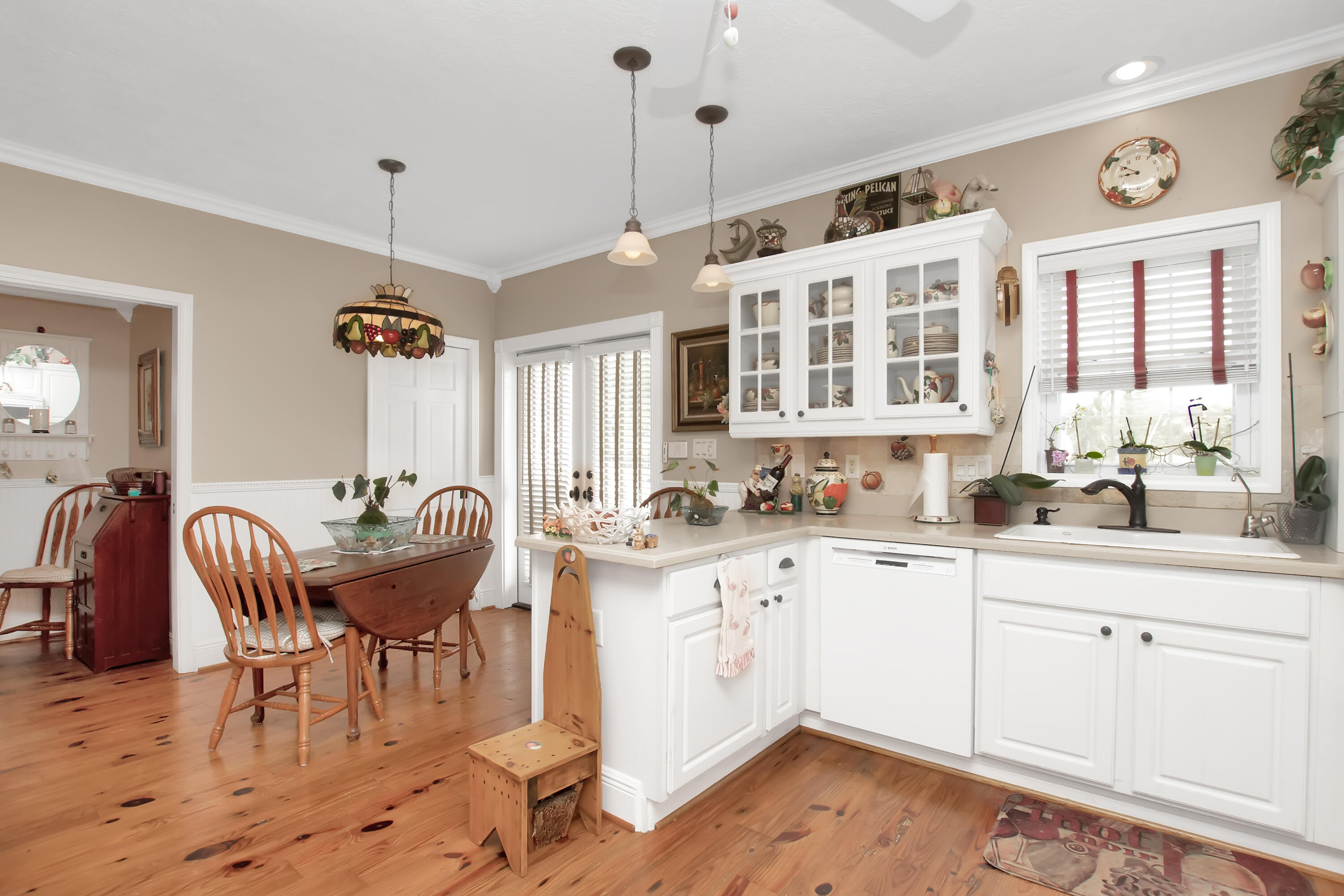 13 Flamingo Road Key Largo, FL 33037 - Photo 21 of 63 a kitchen with stainless steel appliances granite countertop a sink a stove a dining table and chairs with wooden floor
