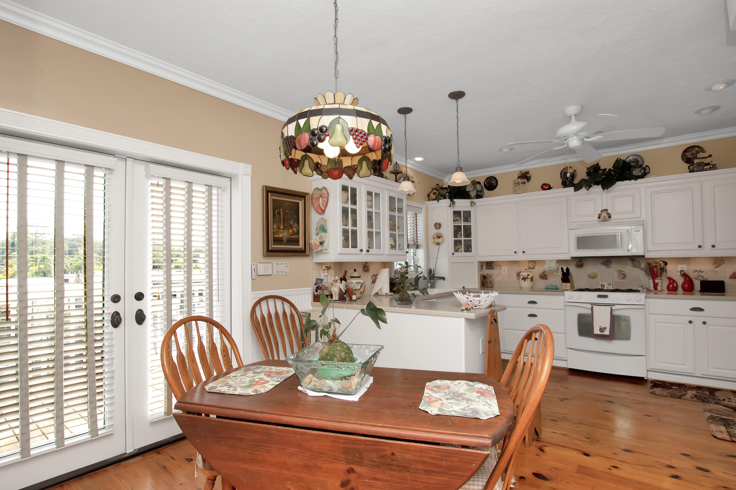 13 Flamingo Road Key Largo, FL 33037 - Photo 24 of 63 a view of a dining room with furniture a chandelier and wooden floor