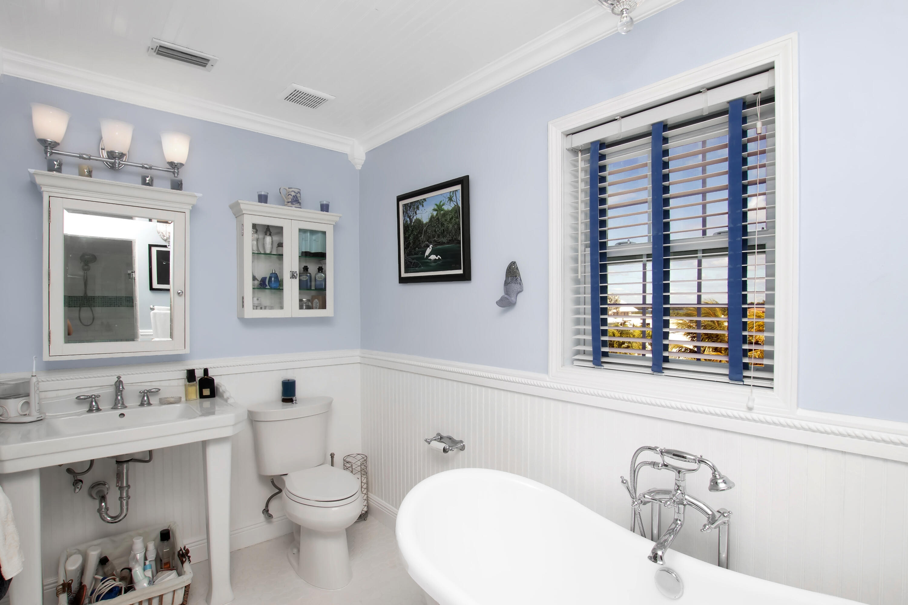 13 Flamingo Road Key Largo, FL 33037 - Photo 38 of 63 a bathroom with a toilet a sink a mirror a window and vanity