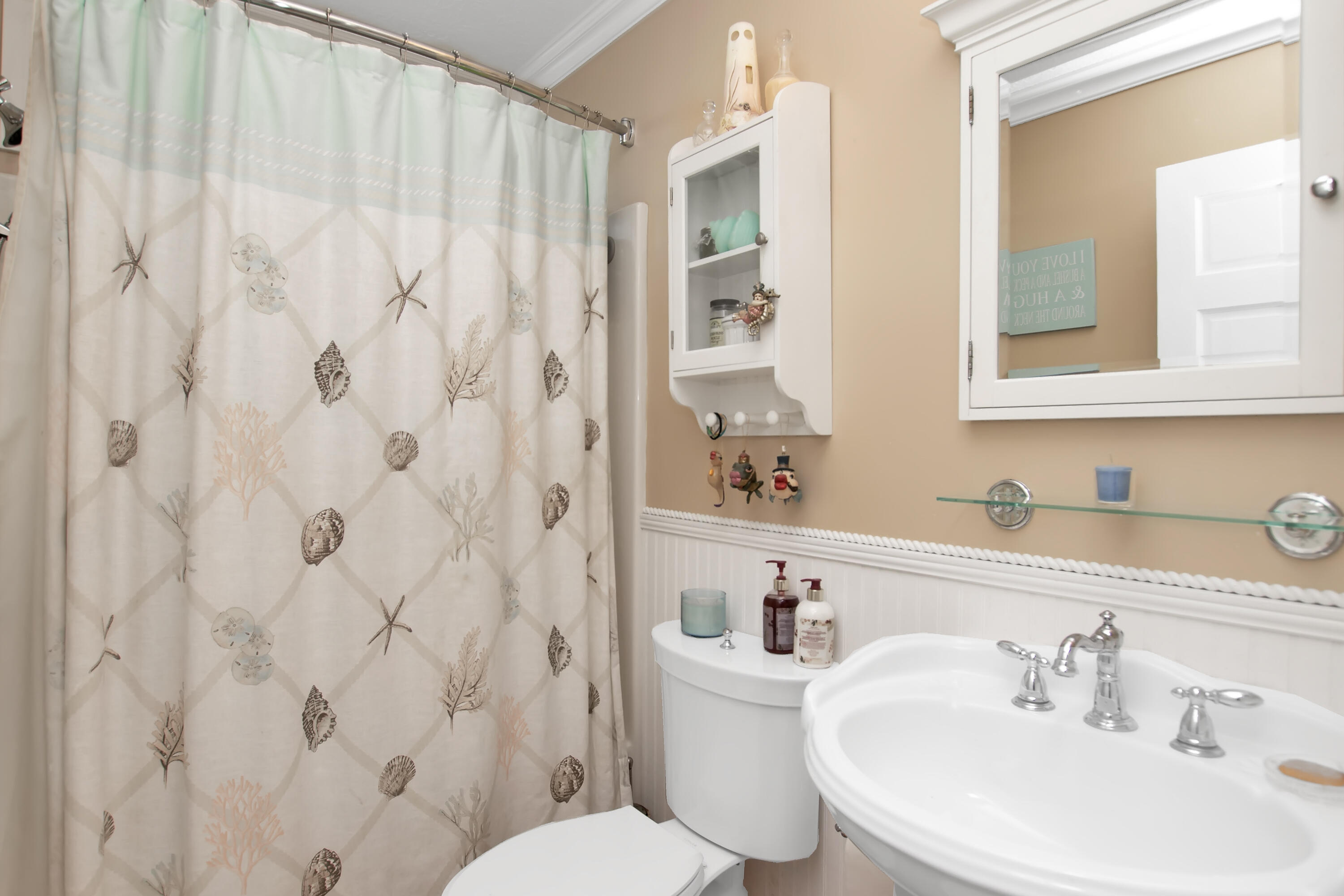 13 Flamingo Road Key Largo, FL 33037 - Photo 45 of 63 a bathroom with a sink a toilet and shower curtain