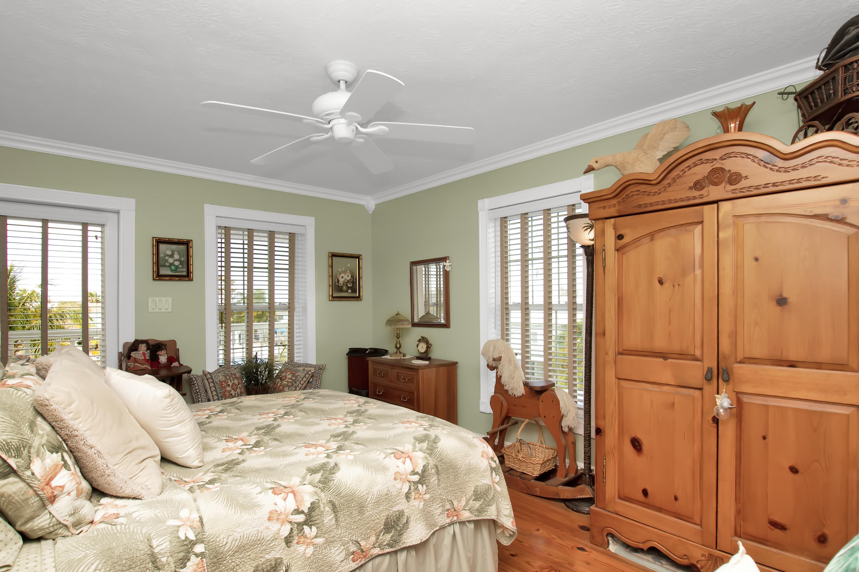 13 Flamingo Road Key Largo, FL 33037 - Photo 46 of 63 a bedroom with a bed a dresser next to a window
