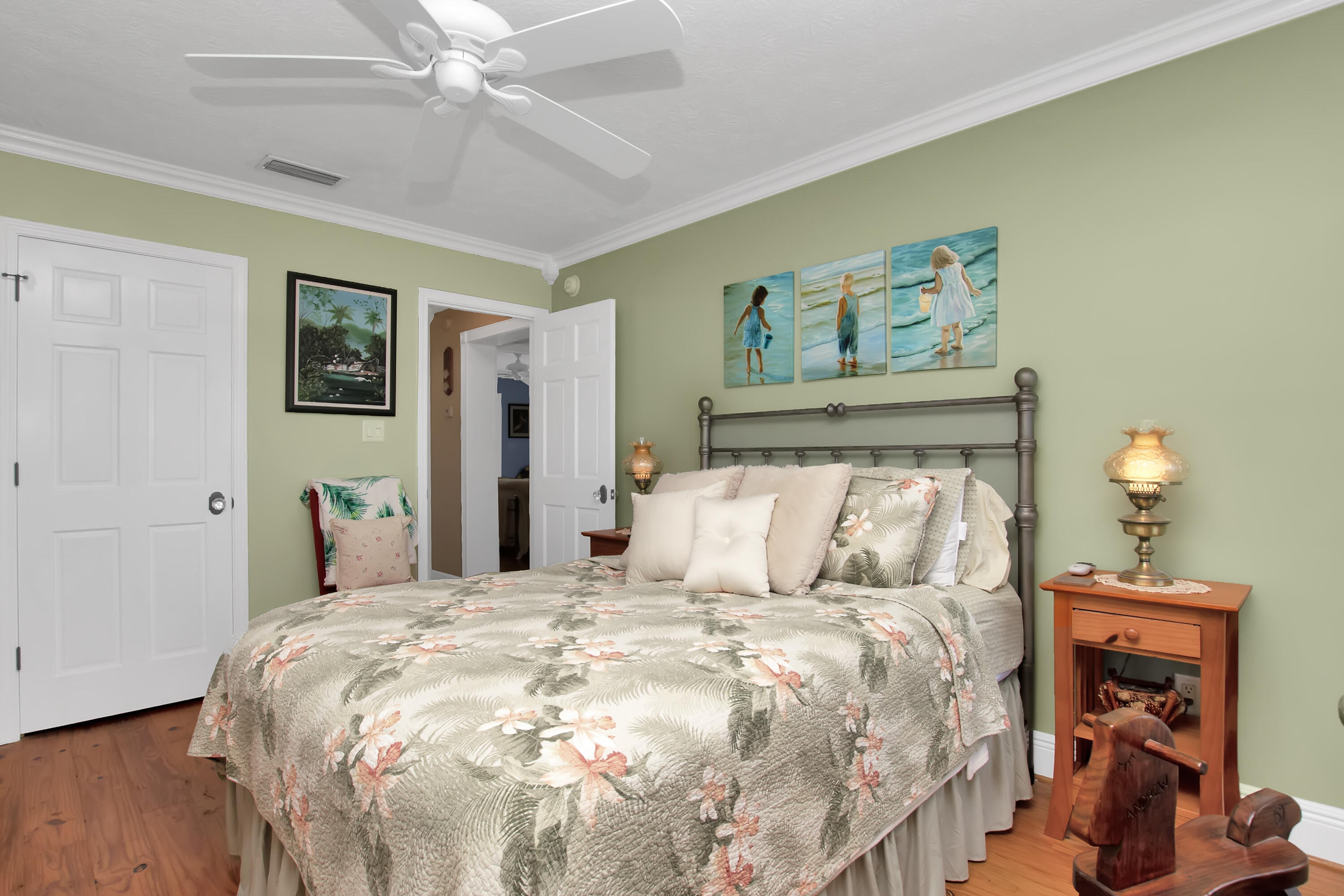 13 Flamingo Road Key Largo, FL 33037 - Photo 48 of 63 a bedroom with a bed and a chandelier