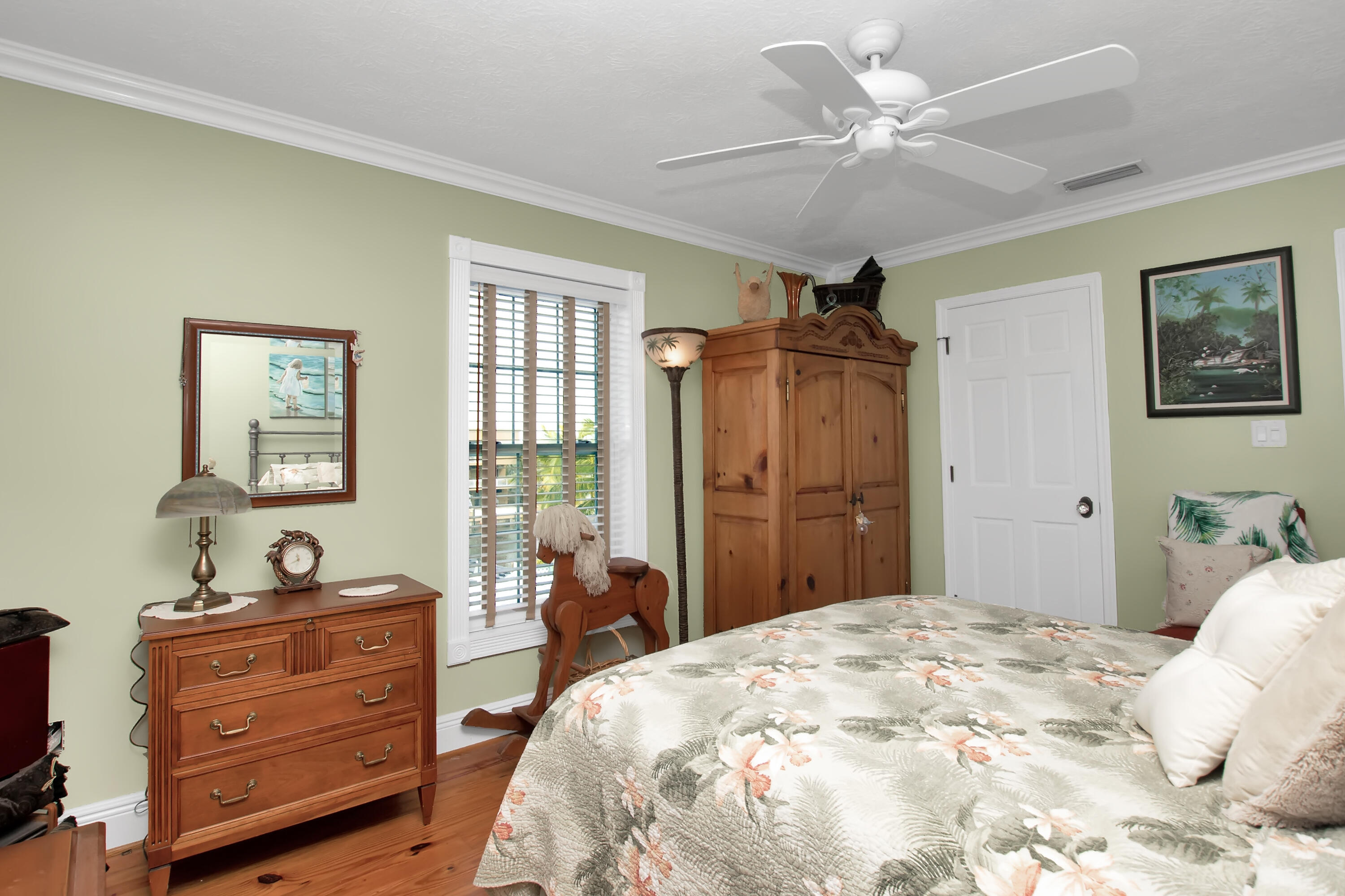 13 Flamingo Road Key Largo, FL 33037 - Photo 49 of 63 a bedroom with a large bed and a chandelier