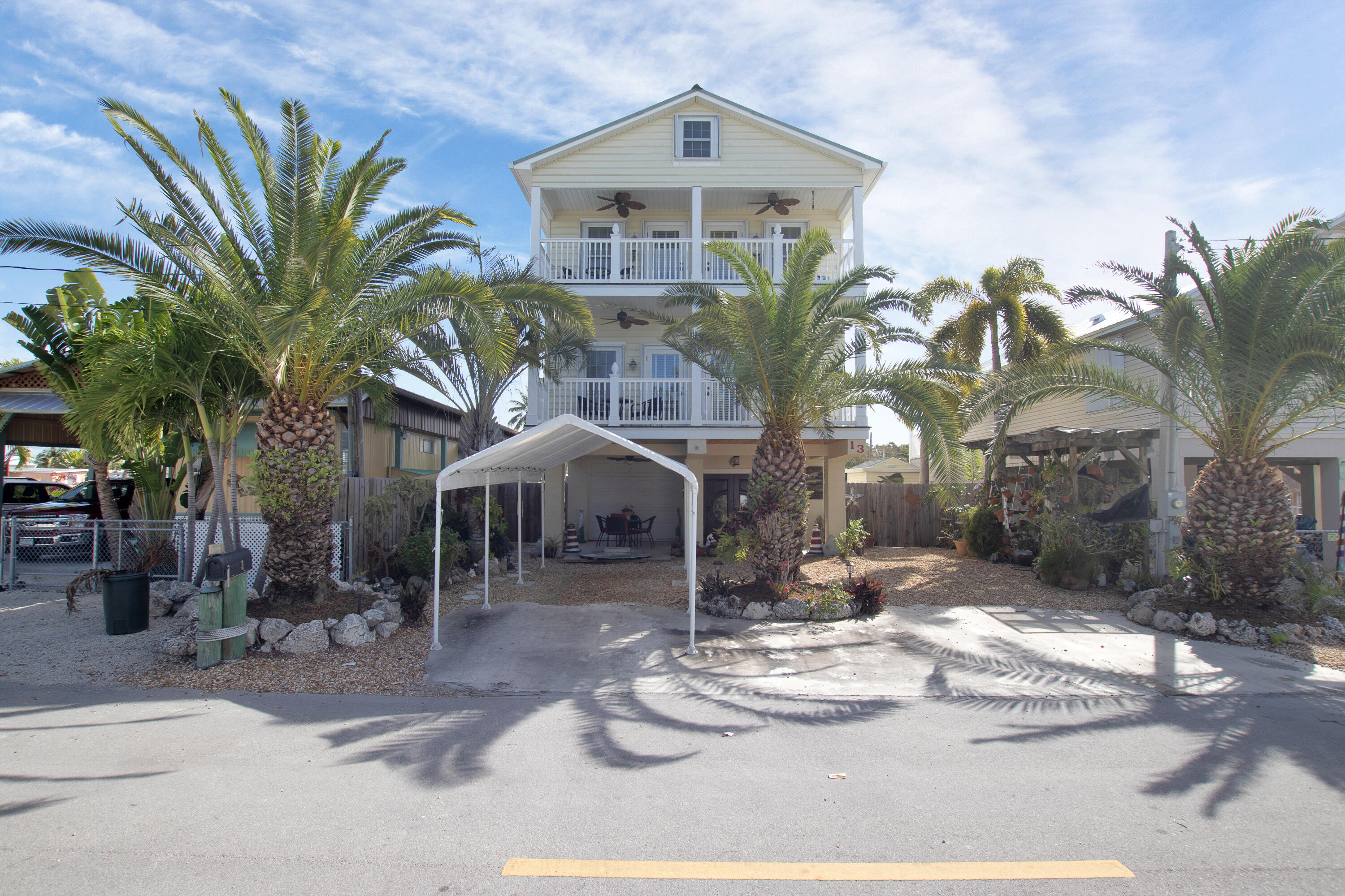 13 Flamingo Road Key Largo, FL 33037 - Photo 9 of 63 a front view of a house with a yard and entryway