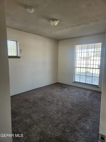 a view of an empty room and a window