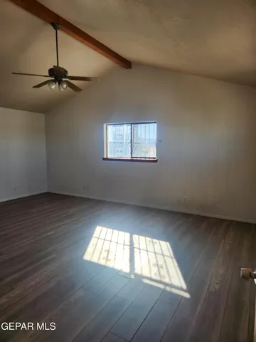 a view of a livingroom with a hall and kitchen view