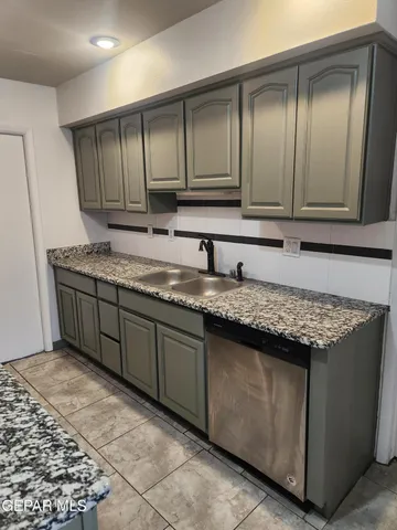 a kitchen with granite countertop cabinets and window