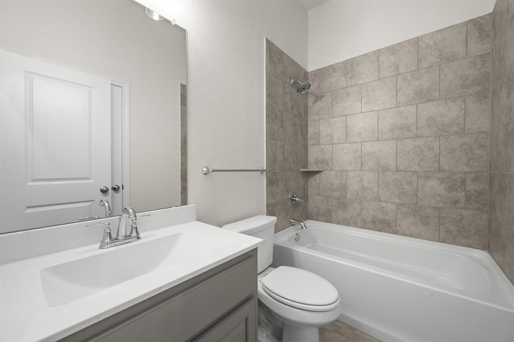 810 Misty Lane Cleburne, TX 76033 - Photo 20 of 30 a bathroom with a sink a toilet and a bathtub