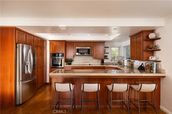 a kitchen with stainless steel appliances granite countertop a sink and a stove