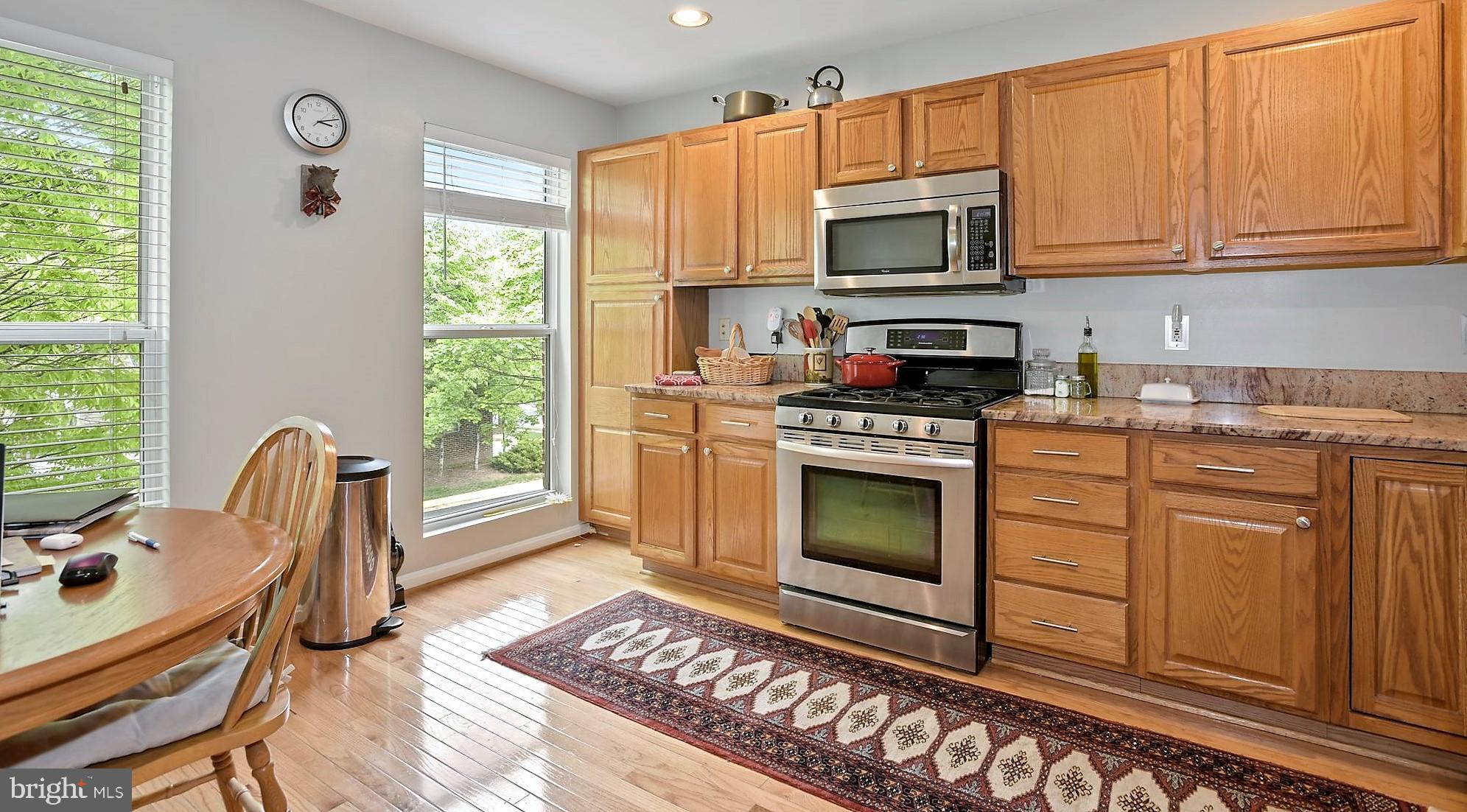 12062 Edgemere Circle Reston, VA 20190 - Photo 5 of 25 a kitchen with a stove a sink and a microwave