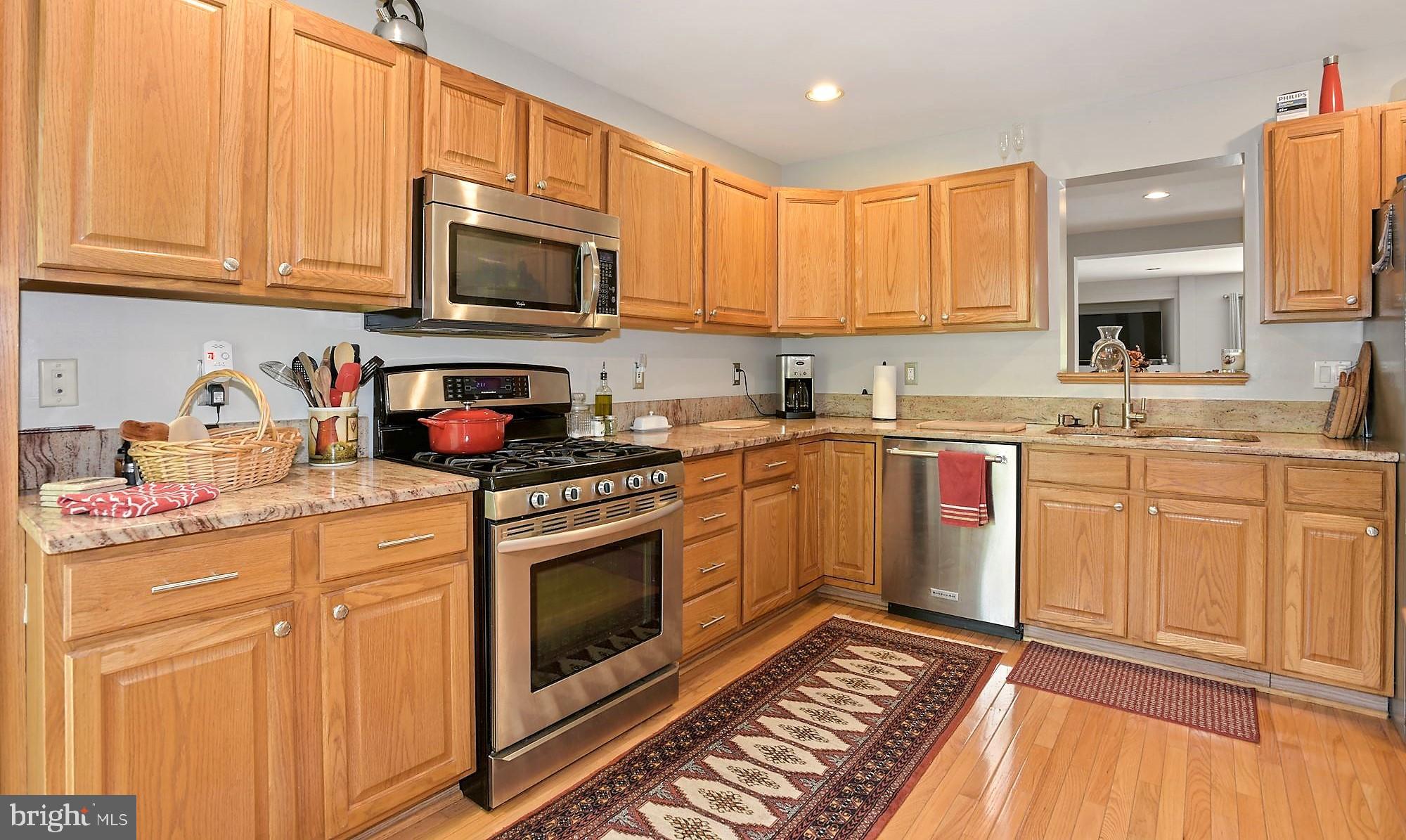 12062 Edgemere Circle Reston, VA 20190 - Photo 6 of 25 a kitchen with stainless steel appliances granite countertop a sink stove and cabinets