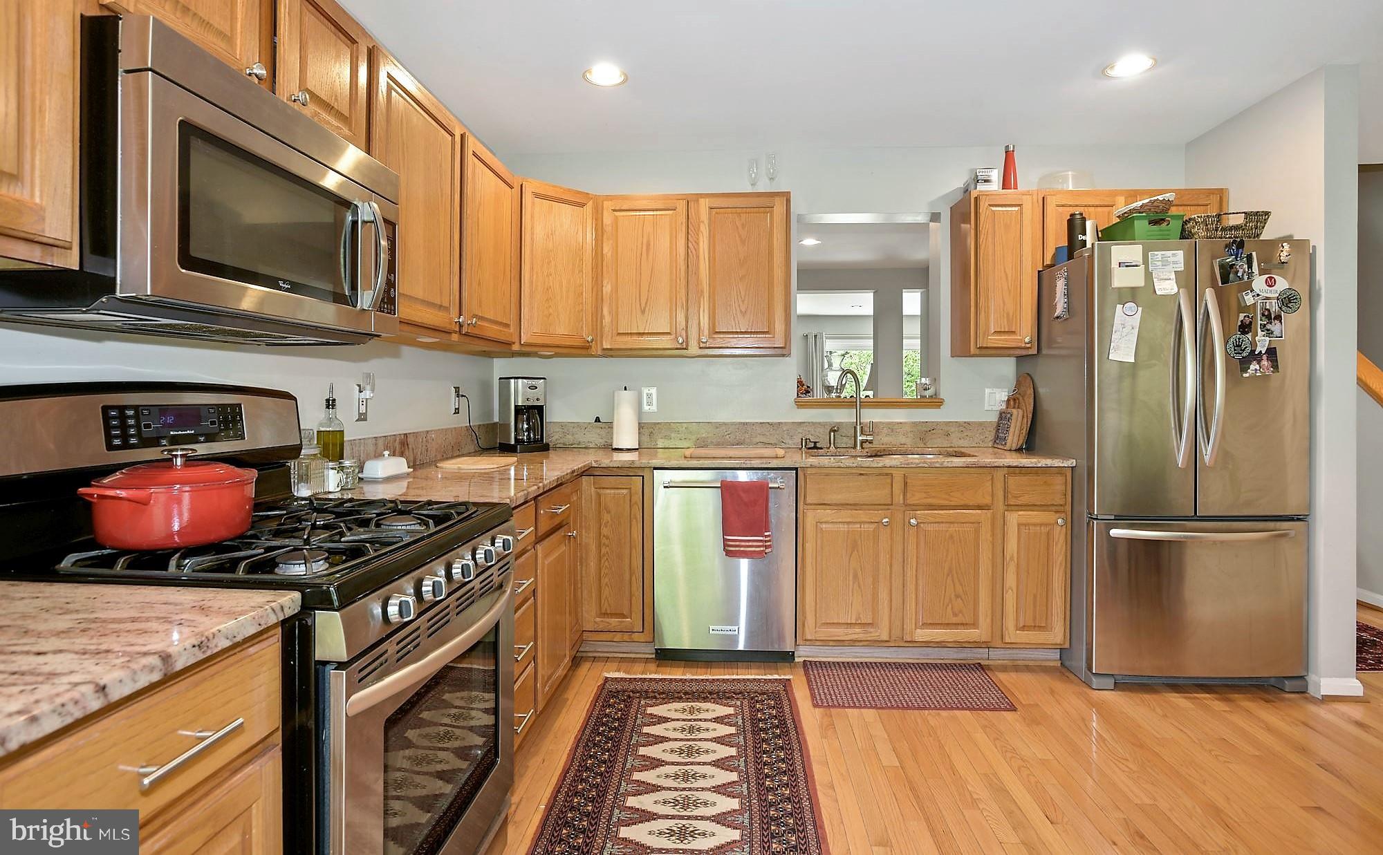 12062 Edgemere Circle Reston, VA 20190 - Photo 7 of 25 a kitchen with stainless steel appliances granite countertop a stove a sink and a refrigerator