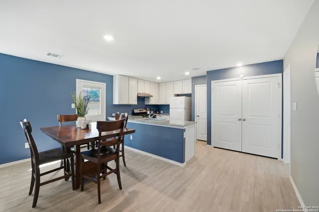 a view of a dining room with furniture and wooden floor