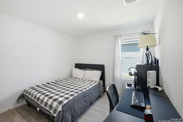 a bedroom with a bed and a lamp on table