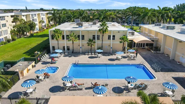 a view of a patio with swimming pool and furniture