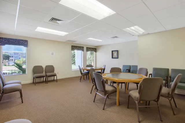 a view of a dining room with furniture and a large window