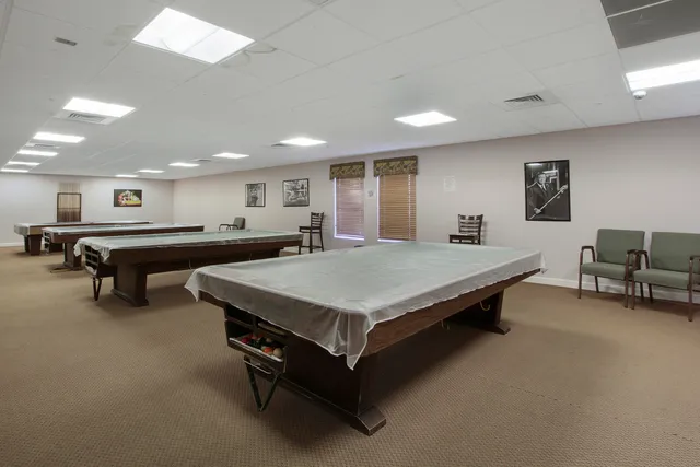 a spacious bedroom with a bed and a large window