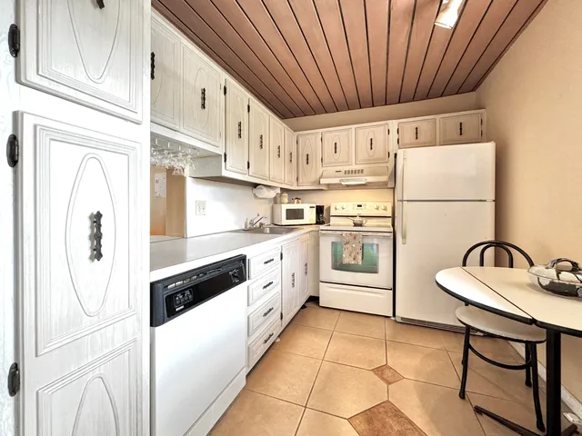 a kitchen with stainless steel appliances a refrigerator sink and cabinets