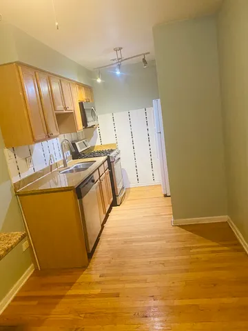 a view of kitchen with granite countertop cabinets