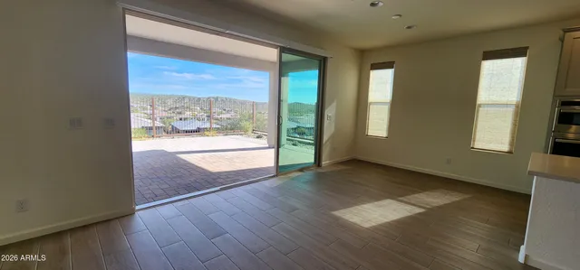 a view of a room with wooden floor and fireplace