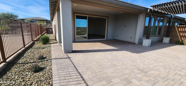 a large living room with stainless steel appliances granite countertop a large window and a refrigerator