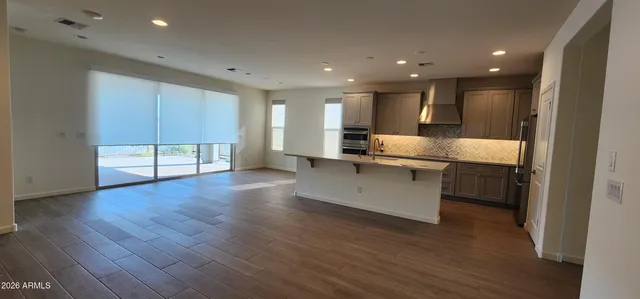 a kitchen with kitchen island granite countertop a sink and wooden cabinets