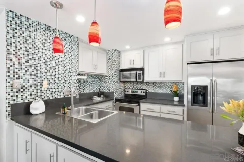 a kitchen with a sink a stove and cabinets