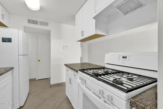 a stove top oven sitting inside of a kitchen