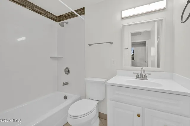 a bathroom with a sink toilet vanity and shower