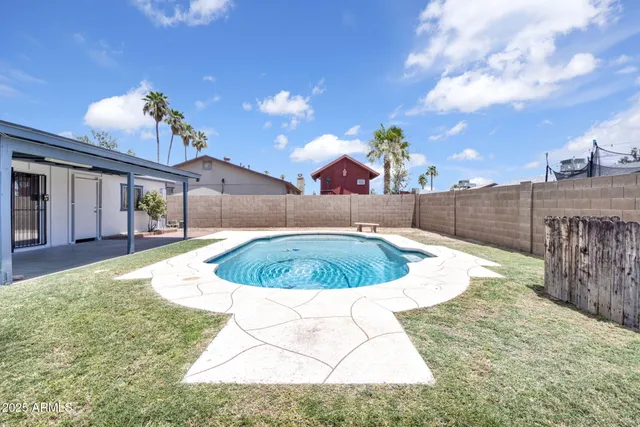 a view of a swimming pool with a yard
