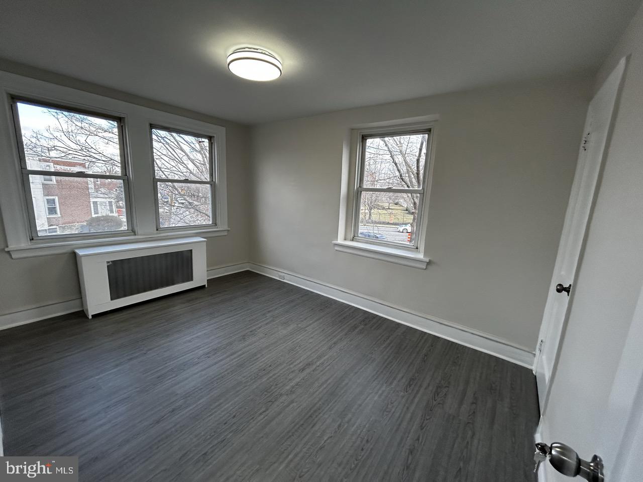 6388 Martins Mill Road Philadelphia, PA 19111 - Photo 8 of 15 a view of an empty room with a window and wooden floor
