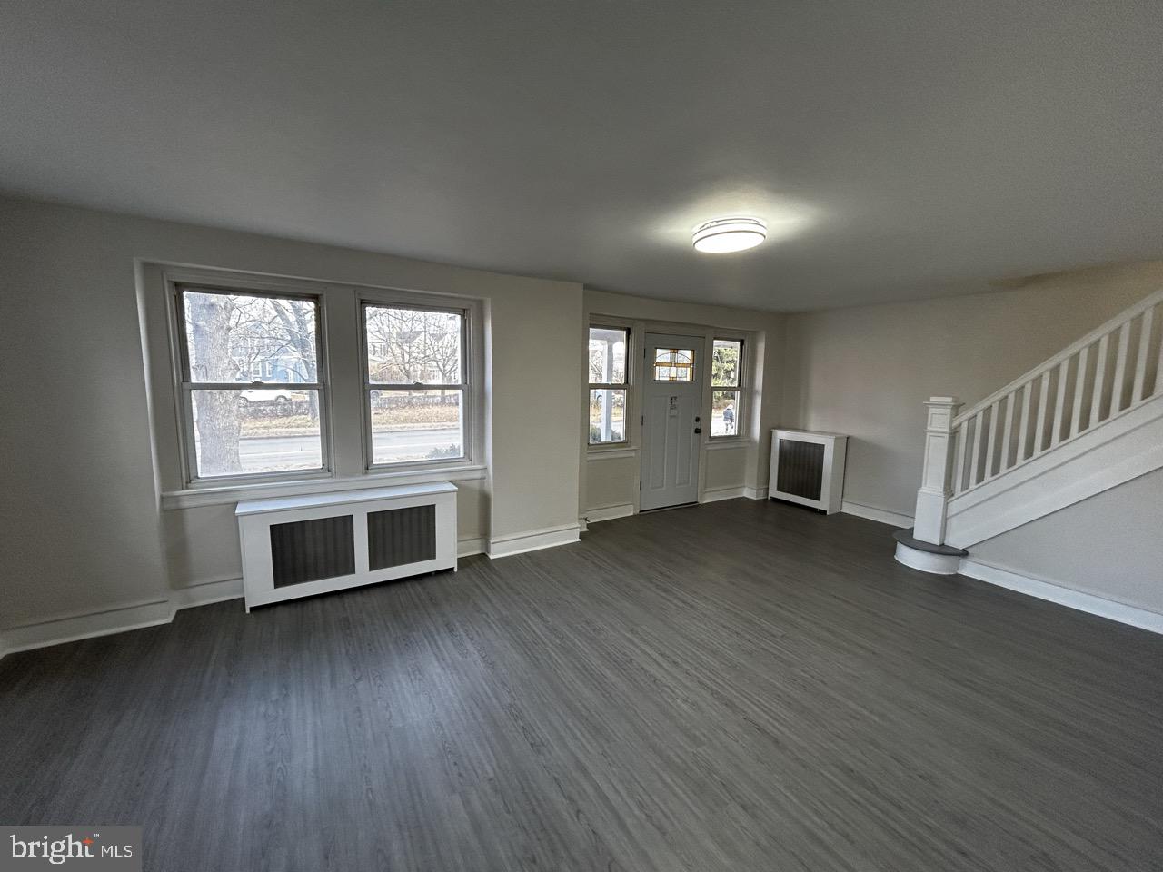 6388 Martins Mill Road Philadelphia, PA 19111 - Photo 10 of 15 an empty room with wooden floor and windows